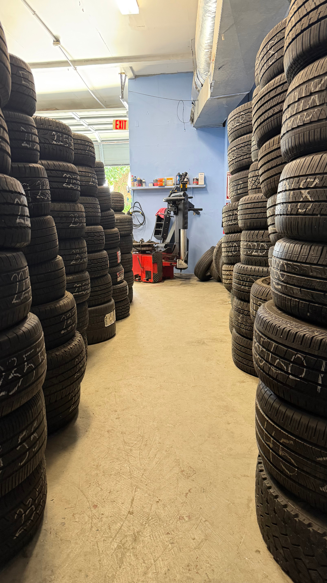 Rows of tires and balancing equipment inside J & B Tires 2